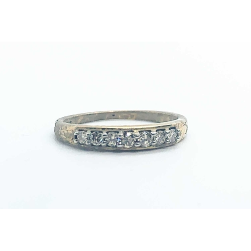 744 - A 9ct yellow gold and diamond ring, set with a row of seven small round-cut diamonds, size N, 1.8 gr... 