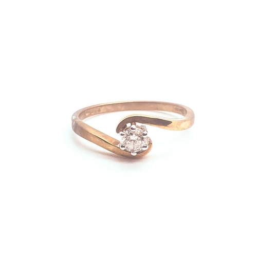 749 - A 9ct yellow gold and solitaire diamond crossover ring, set with a round-cut diamond of approximatel... 