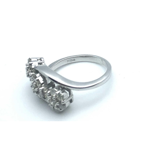 757 - An 18ct white gold and diamond crossover ring, set with three clusters of round brilliant-cut diamon... 