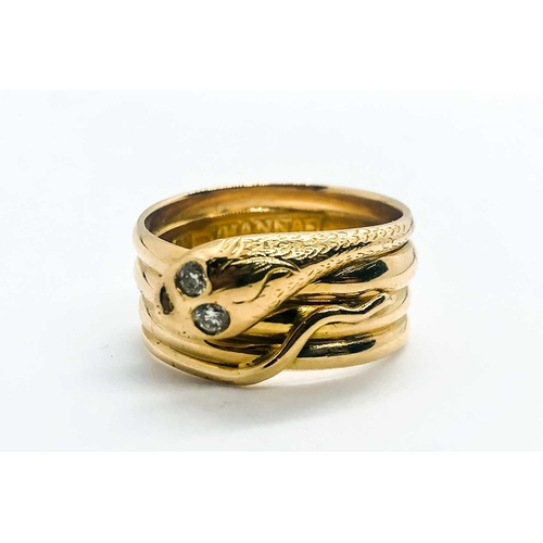 769 - An unusual yellow metal snake ring, the curled snake with two small diamond accent eyes, engraved '2... 