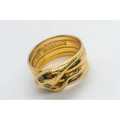 769 - An unusual yellow metal snake ring, the curled snake with two small diamond accent eyes, engraved '2... 