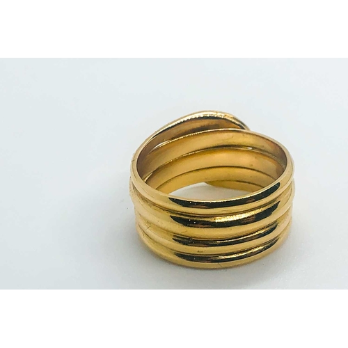 769 - An unusual yellow metal snake ring, the curled snake with two small diamond accent eyes, engraved '2... 