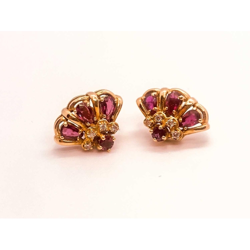 776 - A 14ct yellow gold, diamond, and ruby 'princess' dome ring, set with pear-cut rubies and small diamo... 