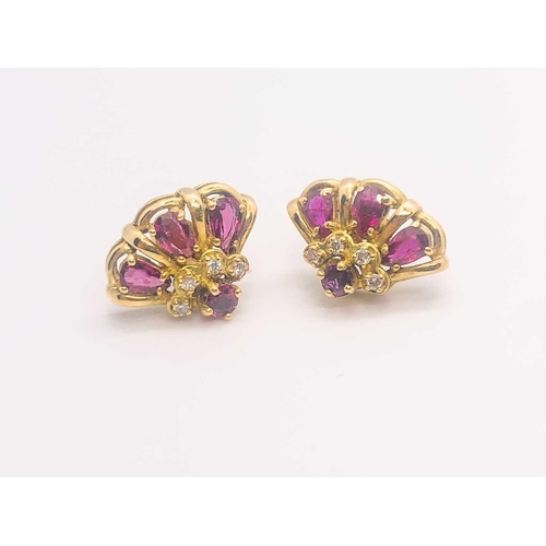 776 - A 14ct yellow gold, diamond, and ruby 'princess' dome ring, set with pear-cut rubies and small diamo... 