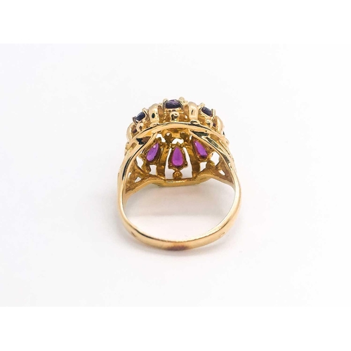 776 - A 14ct yellow gold, diamond, and ruby 'princess' dome ring, set with pear-cut rubies and small diamo... 