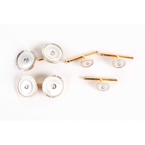 782 - A pair of mother of pearl dress cufflinks and button studs, with diamond set centres, on gold metal ... 