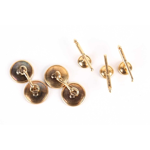 782 - A pair of mother of pearl dress cufflinks and button studs, with diamond set centres, on gold metal ... 