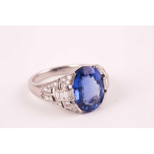 105 - A large sapphire and diamond ring, the mixed star and step-cut oval sapphire mounted between diamond... 