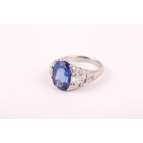 105 - A large sapphire and diamond ring, the mixed star and step-cut oval sapphire mounted between diamond... 