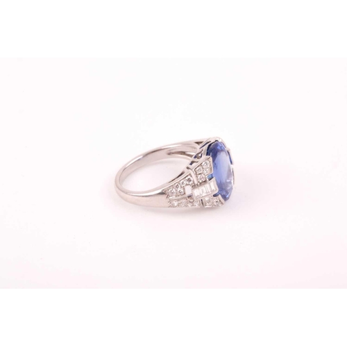 105 - A large sapphire and diamond ring, the mixed star and step-cut oval sapphire mounted between diamond... 