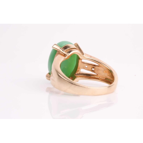 108 - A jade and diamond ring, the oval jade cabochon, 14 x 10 mm, four claw mounts, to open-work diamond ... 