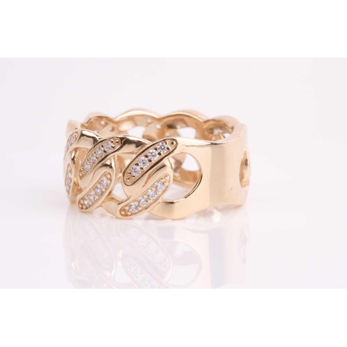 113 - A yellow metal and CZ ring, the mount of a flattened curb-link design inset with round white CZ ston... 