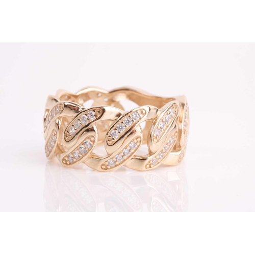 113 - A yellow metal and CZ ring, the mount of a flattened curb-link design inset with round white CZ ston... 