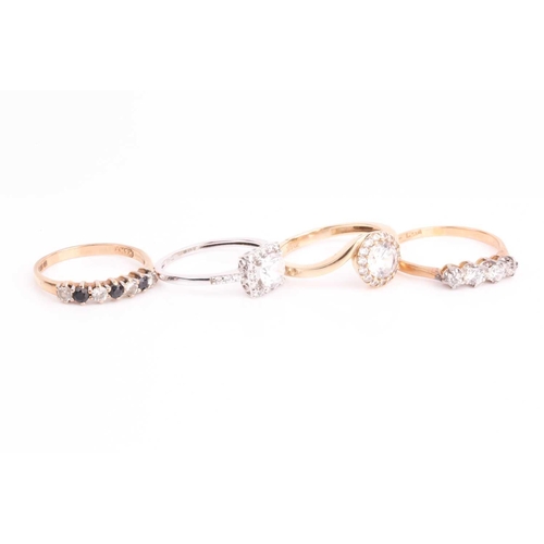 12 - A four stone half hoop ring, comprising two old brilliant cut diamonds and two replacement clear pas... 