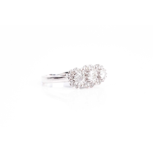 135 - A triple cluster diamond ring, the three slightly graduated brilliant cut diamonds in claw mounts wi... 