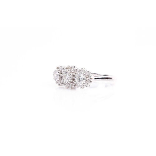 135 - A triple cluster diamond ring, the three slightly graduated brilliant cut diamonds in claw mounts wi... 