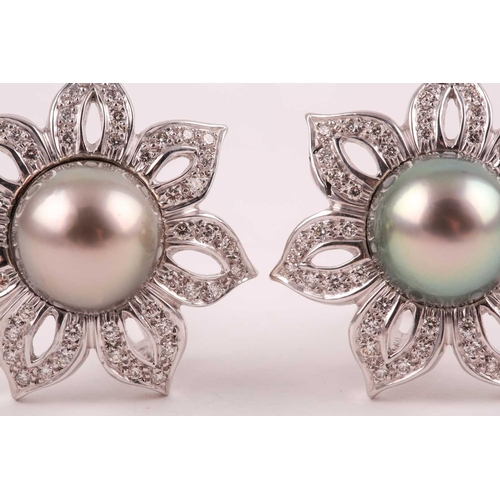 143 - A pair of diamond and Tahitian pearl floral earrings, each set with a large grey pearl of approximat... 