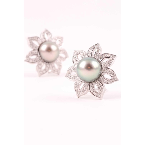 143 - A pair of diamond and Tahitian pearl floral earrings, each set with a large grey pearl of approximat... 