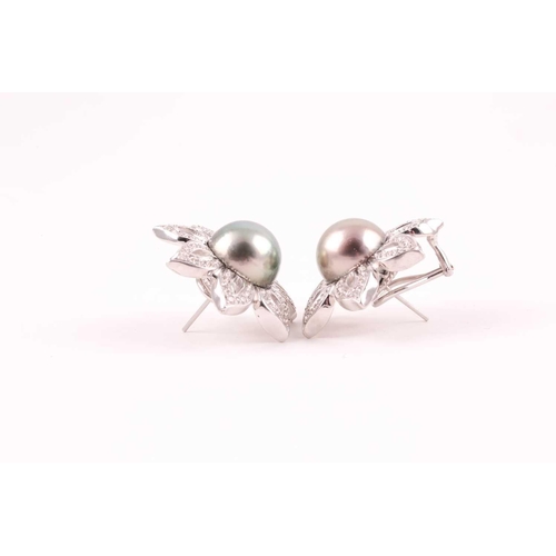 143 - A pair of diamond and Tahitian pearl floral earrings, each set with a large grey pearl of approximat... 