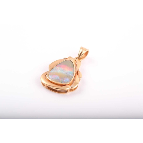 146 - An 18ct yellow gold and boulder opal pendant, of stylised naturalistic design, the mount with matte ... 