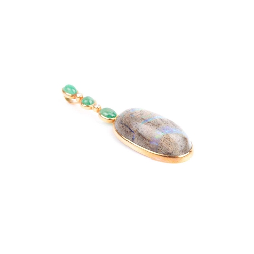 150 - Grima. An unusual 18ct yellow gold, diamond, emerald, and opal pendant, set with an oval cabochon bo... 