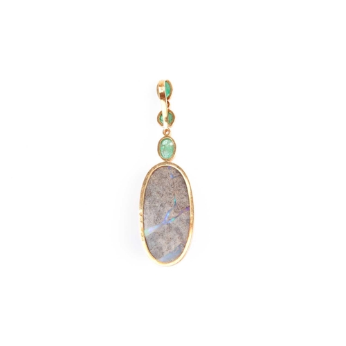 150 - Grima. An unusual 18ct yellow gold, diamond, emerald, and opal pendant, set with an oval cabochon bo... 