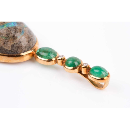 150 - Grima. An unusual 18ct yellow gold, diamond, emerald, and opal pendant, set with an oval cabochon bo... 