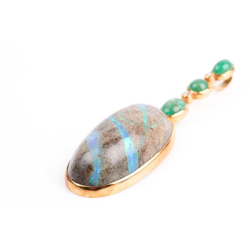 150 - Grima. An unusual 18ct yellow gold, diamond, emerald, and opal pendant, set with an oval cabochon bo... 