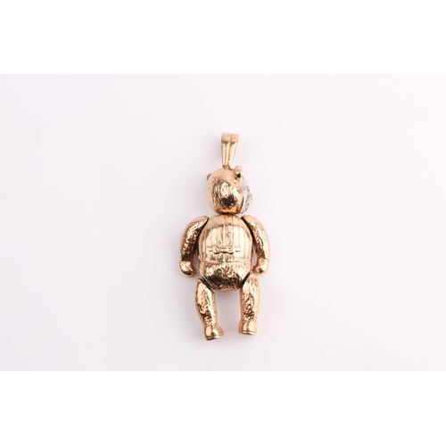 152 - A 9ct gold articulated teddy bear pendant, set with coloured stones, 5cm length. 19.6 grams