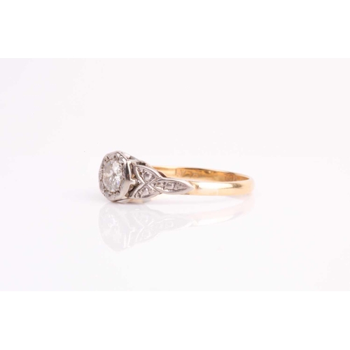 165 - A single stone diamond ring, the round brilliant cut diamond in illusion mount above carved tapering... 