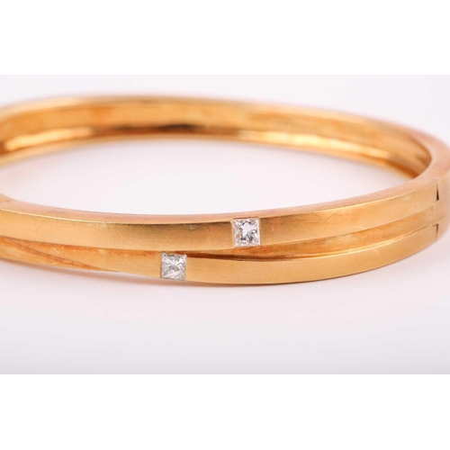 172 - Boodles. An 18ct yellow gold 'Kit and Kaboodle' bracelet, inset with three princess-cut diamonds of ... 