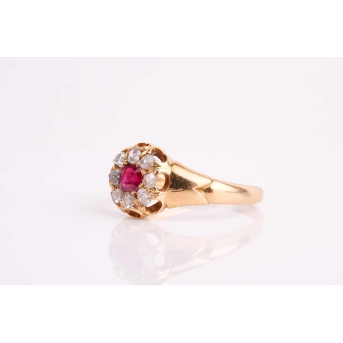 18 - A late 19th / early 20th century yellow metal, diamond, and ruby cluster ring, set with eight old ro... 