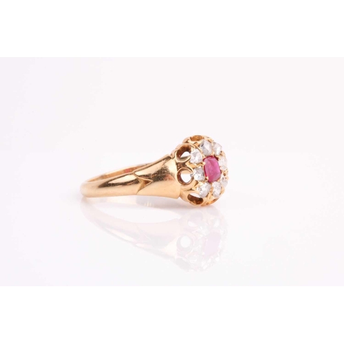 18 - A late 19th / early 20th century yellow metal, diamond, and ruby cluster ring, set with eight old ro... 