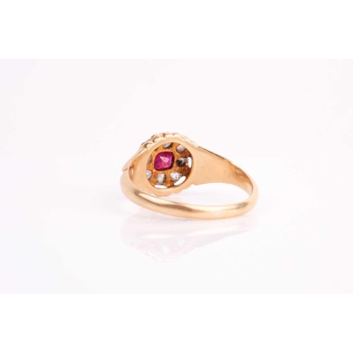 18 - A late 19th / early 20th century yellow metal, diamond, and ruby cluster ring, set with eight old ro... 