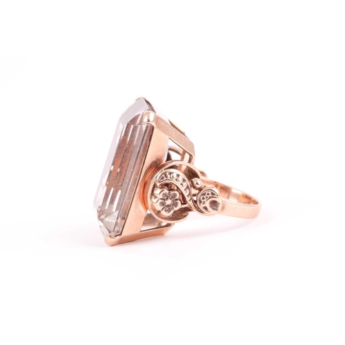 181 - A 9ct yellow gold and smoky quartz cocktail ring, set with a large rectangular-cut quartz 2.4 x 1.8 ... 