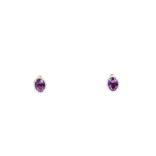 2 - A pair of amethyst and diamond cluster earrings, set with a mixed oval-cut amethyst within a border ... 