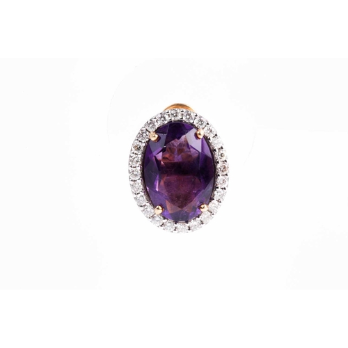 2 - A pair of amethyst and diamond cluster earrings, set with a mixed oval-cut amethyst within a border ... 