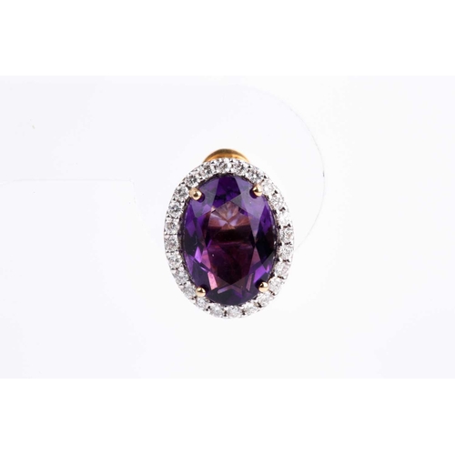 2 - A pair of amethyst and diamond cluster earrings, set with a mixed oval-cut amethyst within a border ... 