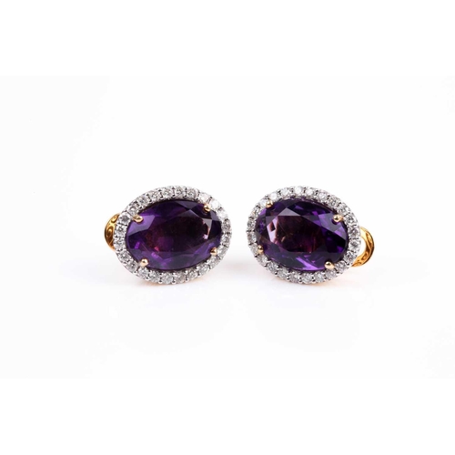 2 - A pair of amethyst and diamond cluster earrings, set with a mixed oval-cut amethyst within a border ... 