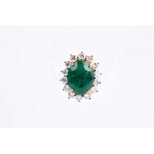 33 - A pair of emerald and diamond cluster earrings, the mixed oval-cut emerald in four claw mount above ... 