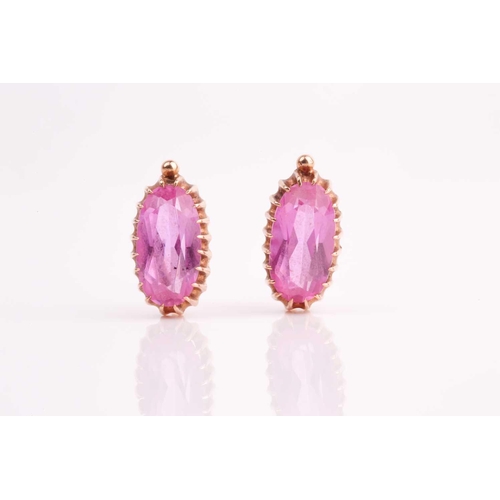 45 - A pair of Russian synthetic pink sapphire pendant earrings, the elongated oval stones in claw mounts... 