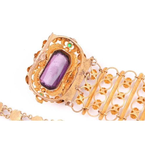 48A - A late 19th / early 20th century gilt metal bracelet, set with a large faceted amethyst-coloured gla... 