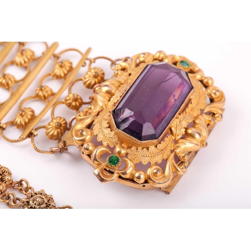 48A - A late 19th / early 20th century gilt metal bracelet, set with a large faceted amethyst-coloured gla... 