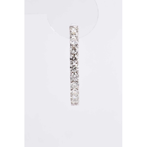 54 - A fine pair of diamond earrings, each set with round brilliant-cut diamonds to the front of the hoop... 