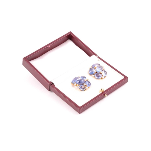 55 - A pair of cabochon sapphire and diamond cluster earrings; the ten mixed size polished stones claw-mo... 