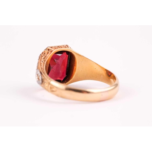 59 - A gentleman's yellow gold and garnet ring, set with a mixed rectangular-cut garnet, measuring approx... 