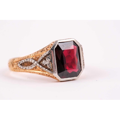 59 - A gentleman's yellow gold and garnet ring, set with a mixed rectangular-cut garnet, measuring approx... 