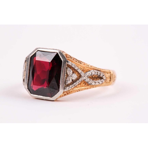 59 - A gentleman's yellow gold and garnet ring, set with a mixed rectangular-cut garnet, measuring approx... 