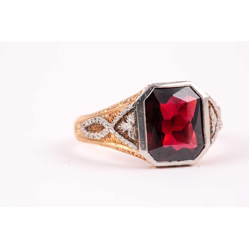 59 - A gentleman's yellow gold and garnet ring, set with a mixed rectangular-cut garnet, measuring approx... 