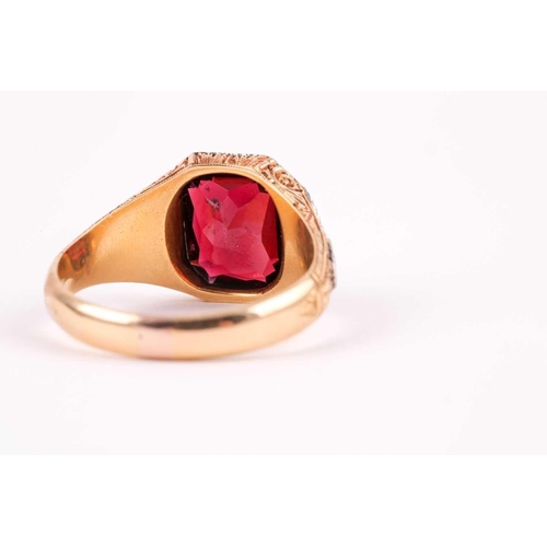 59 - A gentleman's yellow gold and garnet ring, set with a mixed rectangular-cut garnet, measuring approx... 